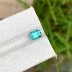 Discover the captivating beauty of this 1.00-carat Natural Tourmaline from Afghanistan, featuring an elegant Emerald cut and a distinctive lagoon blue color. Measuring 6.4 × 4.6 × 3.5 mm, this natural and untreated loose Tourmaline showcases an attractive blue tone with a refined faceted appearance.