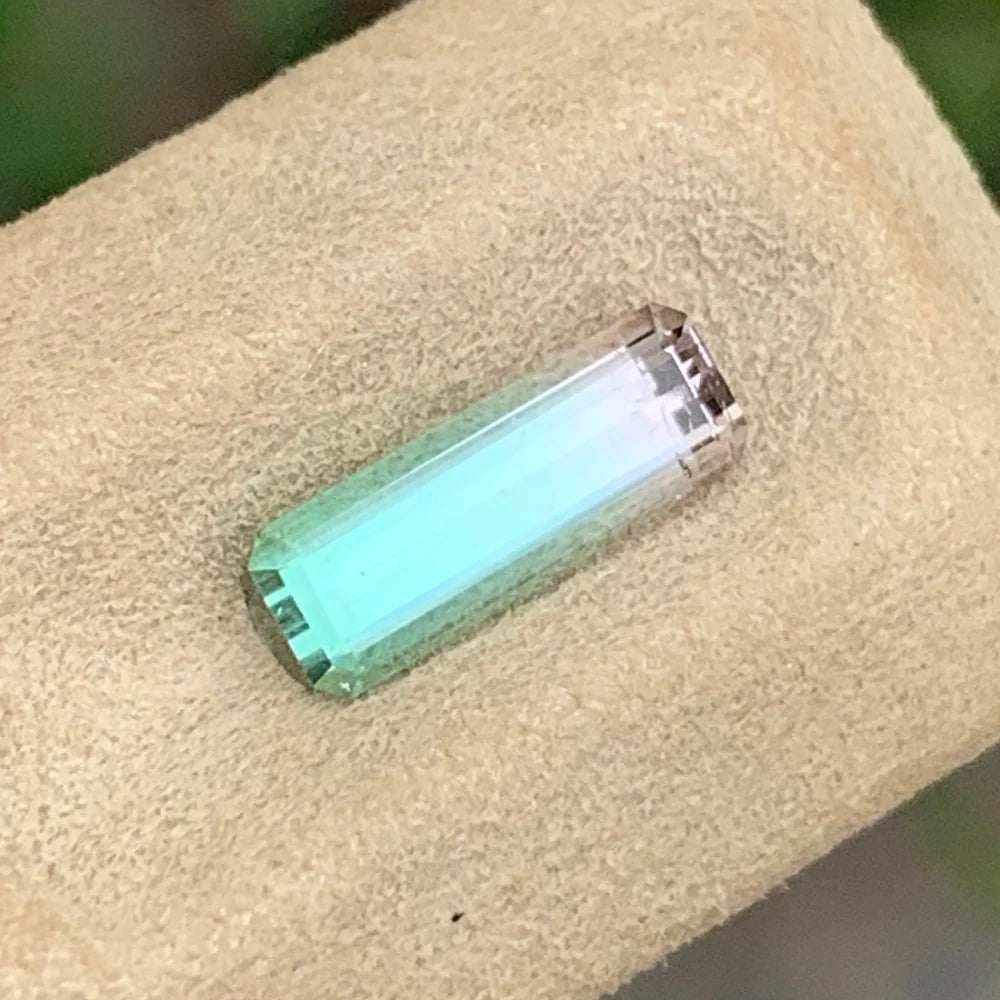 Shop a 1.40 Ct Watermelon Tourmaline from Afghanistan, featuring an Emerald Cut and contrasting green and pink colors in an untreated gemstone.