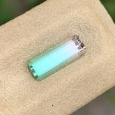 Shop a 1.40 Ct Watermelon Tourmaline from Afghanistan, featuring an Emerald Cut and contrasting green and pink colors in an untreated gemstone.