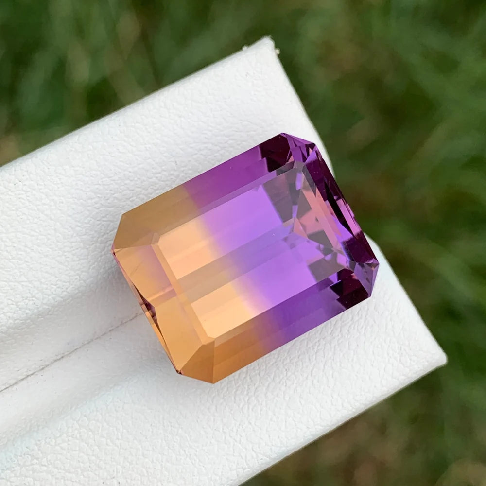 Shop a 26.25 Ct Ametrine from Bolivia featuring an Emerald cut and natural amethyst-citrine color zoning for statement jewelry and collectors.