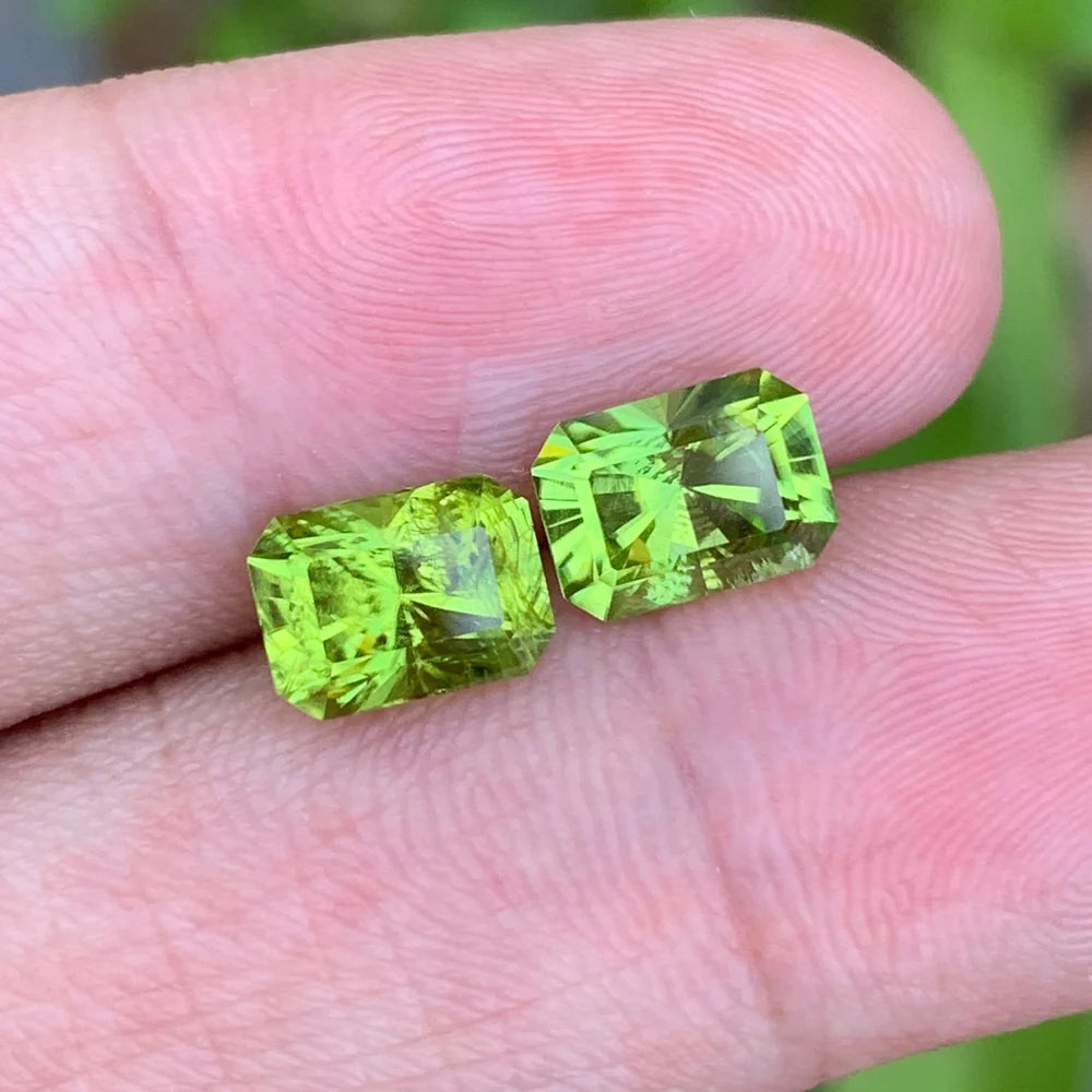 Discover the vibrant beauty of this 3.55-carat natural peridot pair from Pakistan, featuring a beautiful bright green color and elegant emerald cuts. 