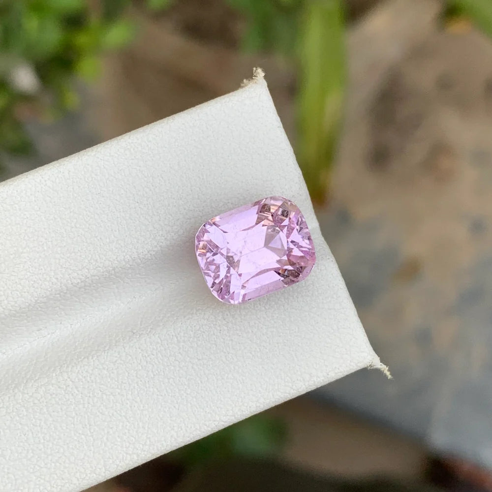Discover the elegant beauty of this 9.15-carat light pink kunzite gemstone from Afghanistan, expertly cut in a beautiful cushion shape.