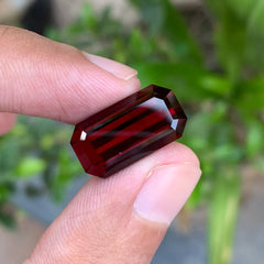 Shop a 14.20 Ct deep red rhodolite garnet from Africa with an elegant emerald cut. Untreated January birthstone for custom jewelry and collections.