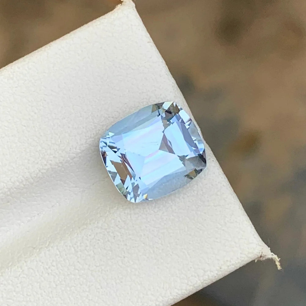 Discover the unique beauty of this 4.50-carat goshenite gemstone, featuring a delicate light purplish blue color and an elegant cushion cut.