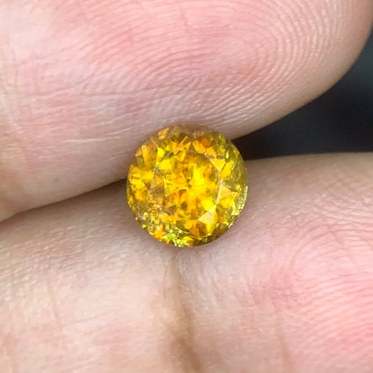 orangish yellow titanite gemstone close-up brilliant fire