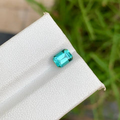 Discover the captivating beauty of this 1.00-carat Natural Tourmaline from Afghanistan, featuring an elegant Emerald cut and a distinctive lagoon blue color. 