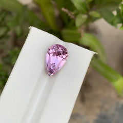 Discover the delicate beauty of this 10.25-carat Kunzite from Afghanistan, featuring an elegant Pear cut and a soft light pink color. 