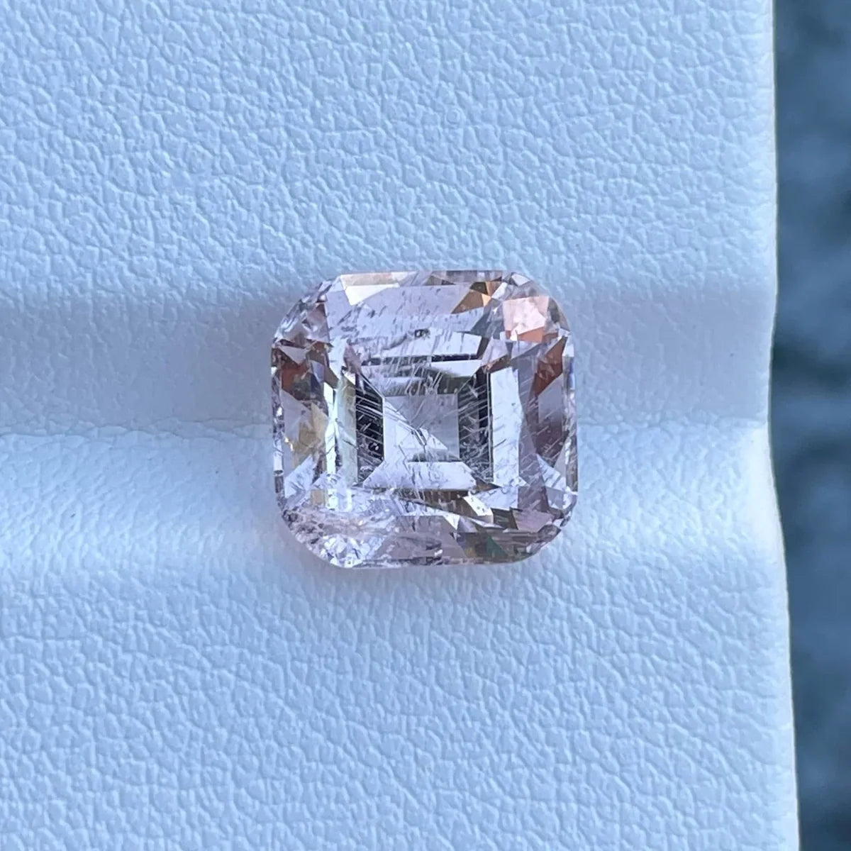 Natural loose morganite gemstone in a soft peach-pink shade with a faceted cut.