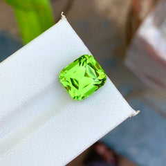 Shop this 7.50 ct apple green peridot from Pakistan. Natural untreated cushion cut loose gemstone and beautiful August birthstone for custom jewelry.