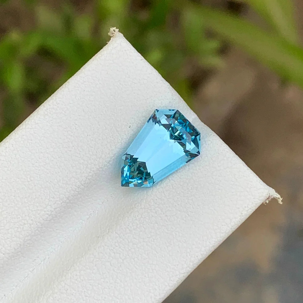 Discover the refreshing beauty of this 5.60-carat Sky Blue Topaz from Brazil, featuring an elegant Shield cut